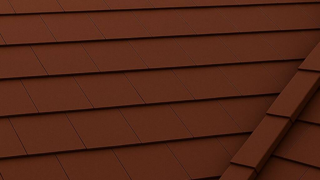 Obrazek przedstawia brązową dachówkę płaską na dachu